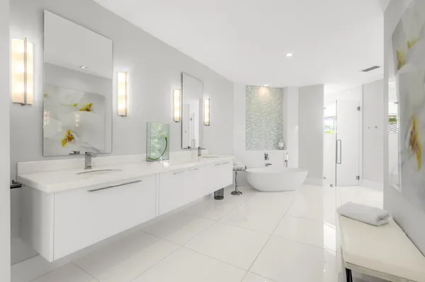 a bathroom with a sink mirror and a toilet