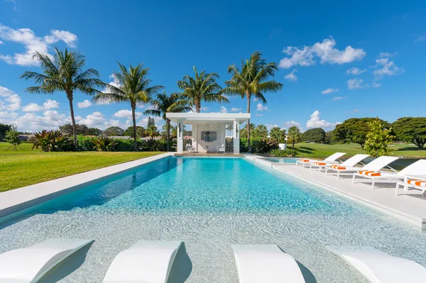 a view of a swimming pool with a table and chairs