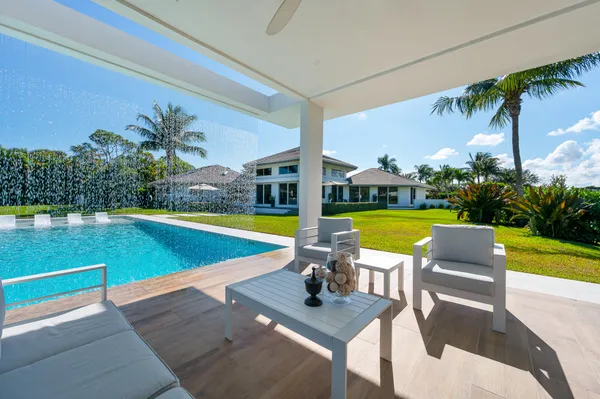 a view of a house with swimming pool and a yard