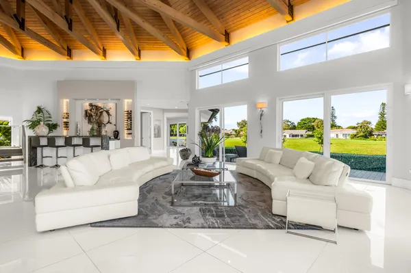 a living room with furniture and a floor to ceiling window