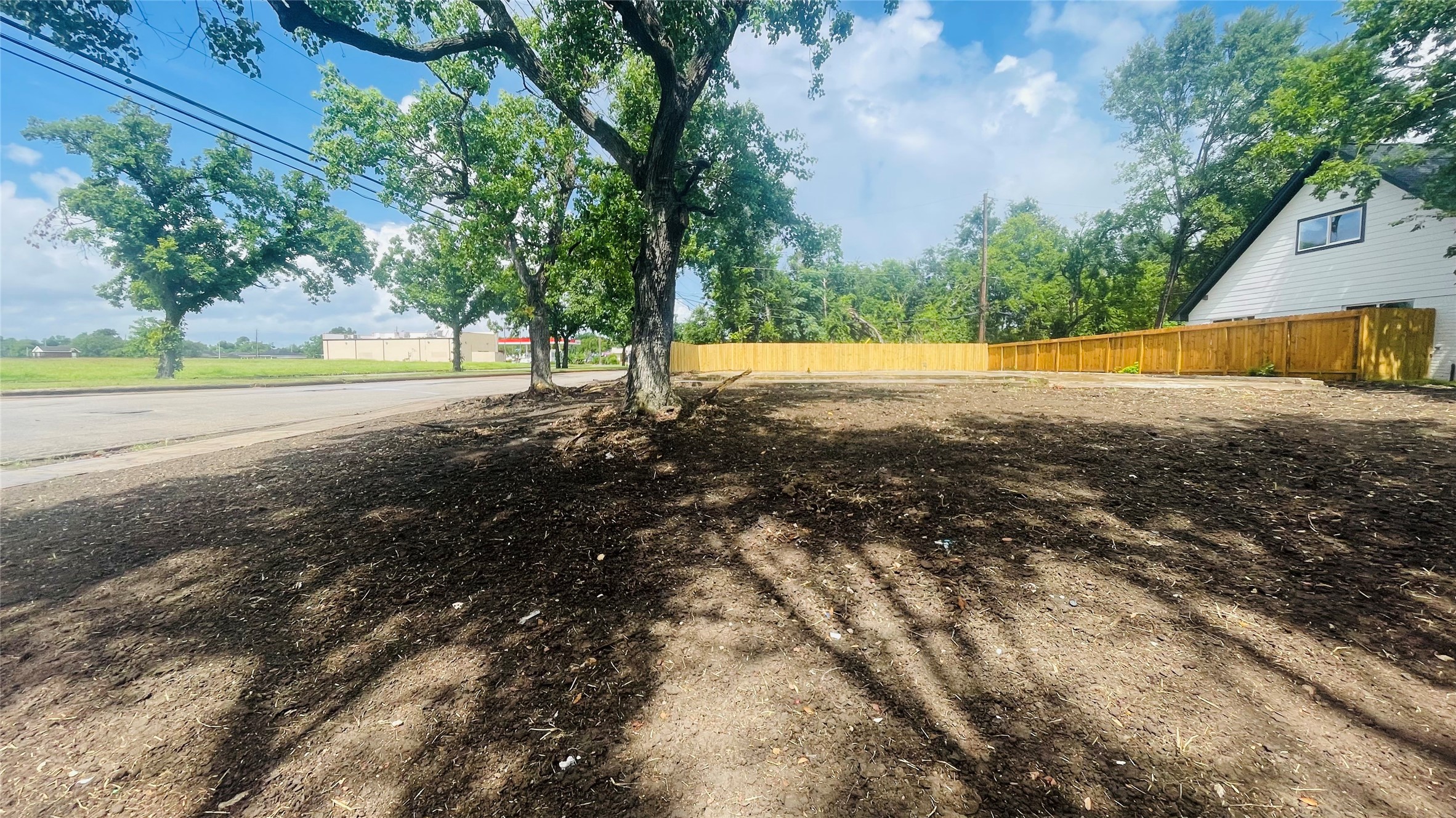 a view of yard with swimming pool and trees