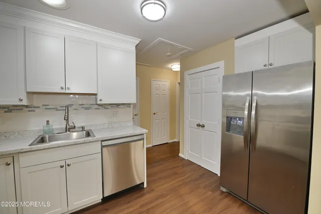 a kitchen with a sink cabinets and stainless steel appliances