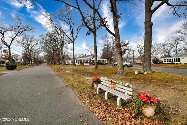 a view of a street with cars on both side of the road