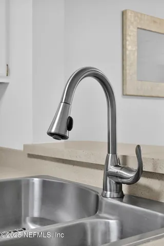 a bedroom with a large bed chandelier and a window