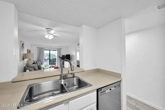 a bedroom with a bed a flat screen tv and a couch