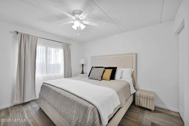 a bedroom with a flat screen tv on the dresser and a dishwasher