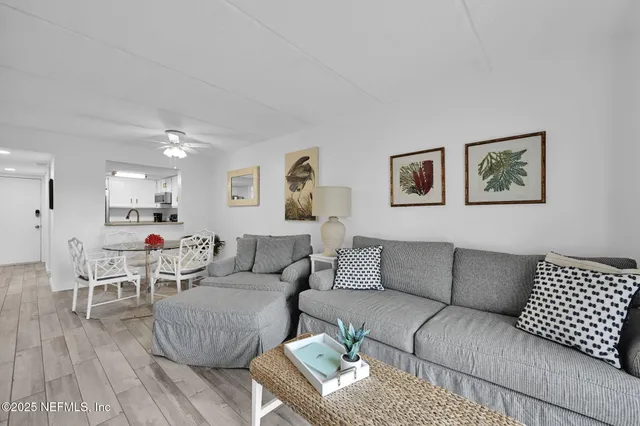 a kitchen with stainless steel appliances white cabinets white stove a microwave and a refrigerator