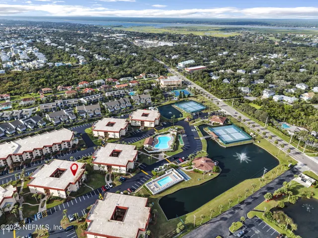 a park view with a fountain plants and large tree