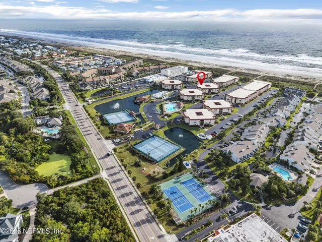 a view of a dry yard with wooden fence