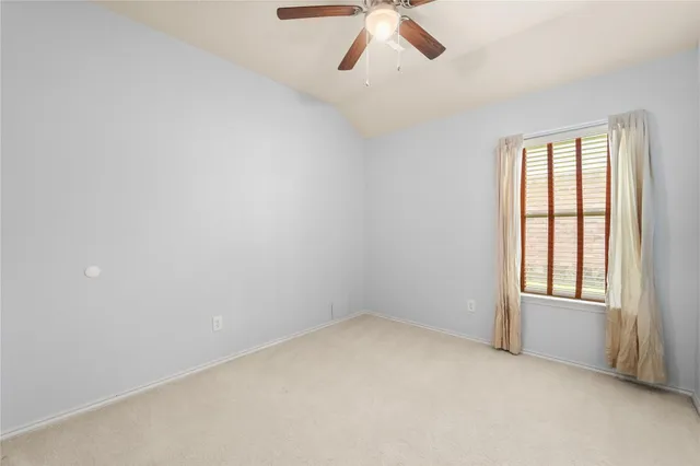 an empty room with a empty space and a ceiling fan