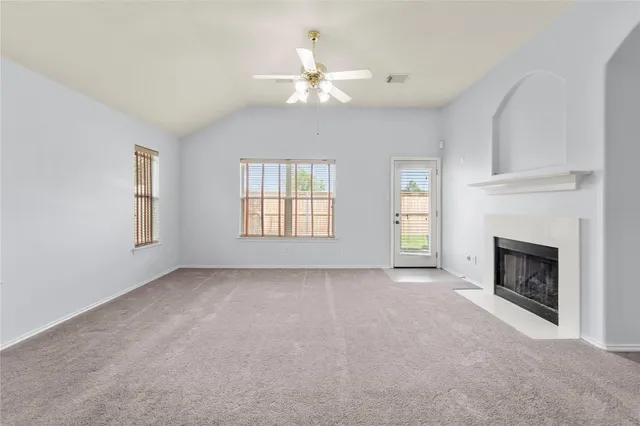 a view of empty room with fireplace