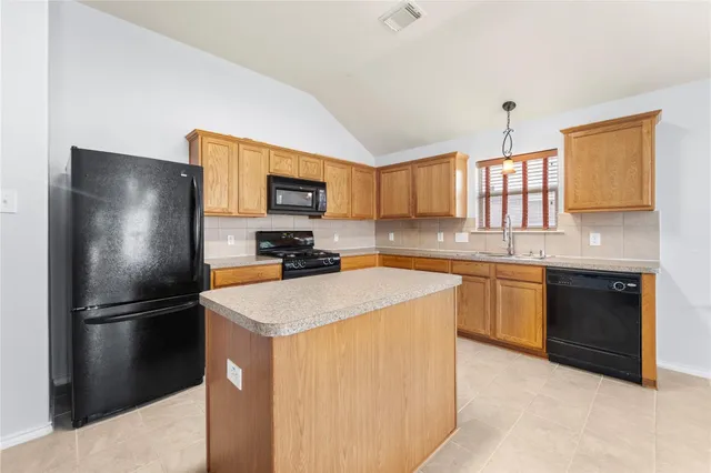 a kitchen with stainless steel appliances granite countertop a refrigerator stove microwave and sink