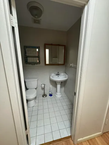 a view of bathroom with a sink and mirror
