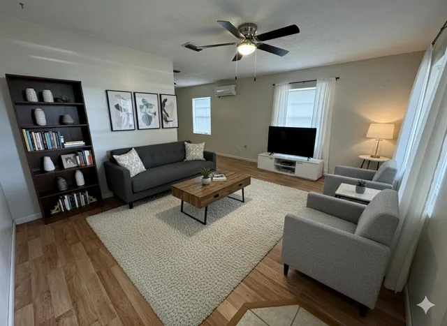 a living room with furniture and a flat screen tv