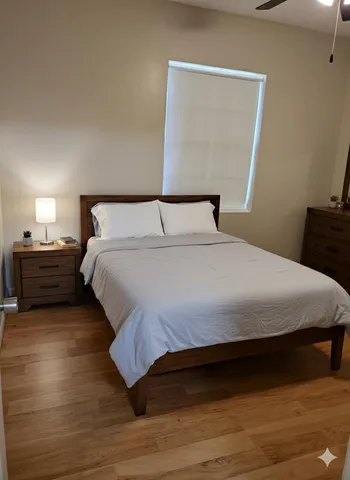 a bedroom with a bed and a night stand