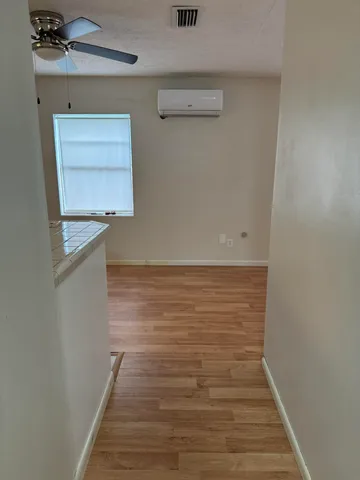 a view of room with wooden floor