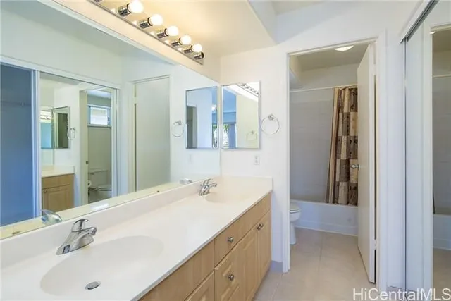 a bathroom with a double vanity sink and mirror