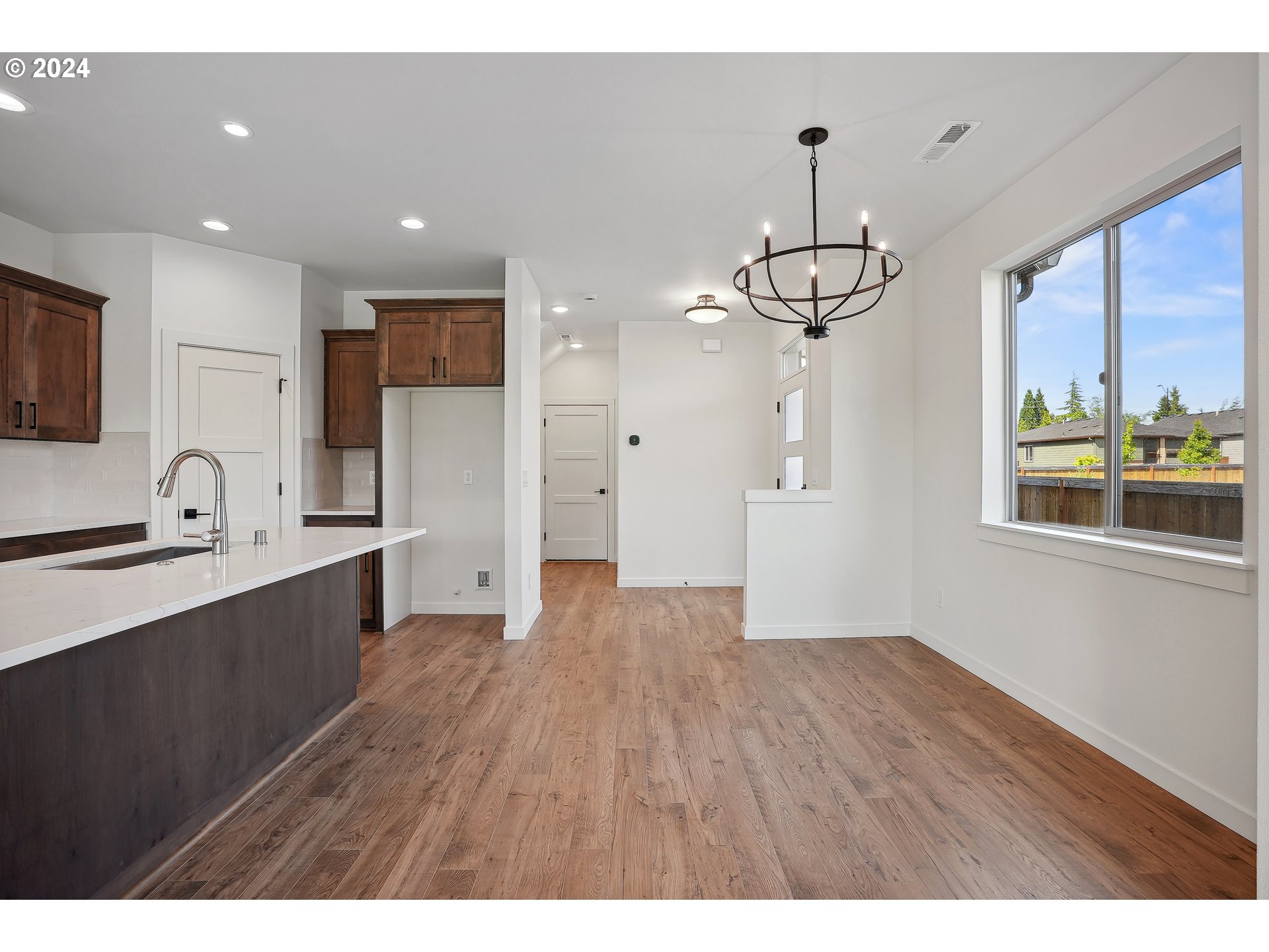 2541 South White Salmon Drive Ridgefield, WA 98642 - Photo 4 of 29 a view of a kitchen with wooden floor and a window