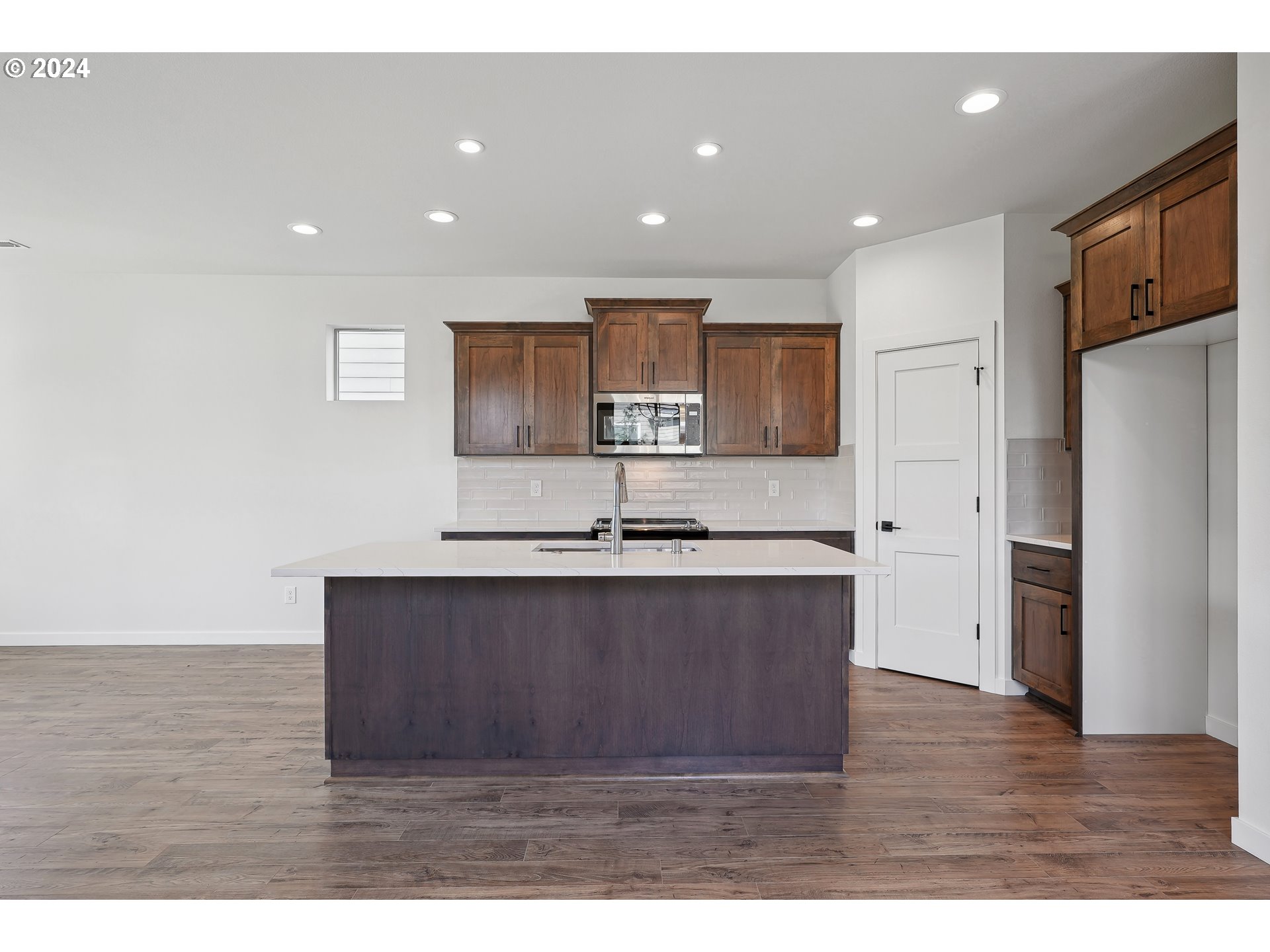 2541 South White Salmon Drive Ridgefield, WA 98642 - Photo 6 of 29 a large kitchen with stainless steel appliances a large counter top a stove a refrigerator and a sink