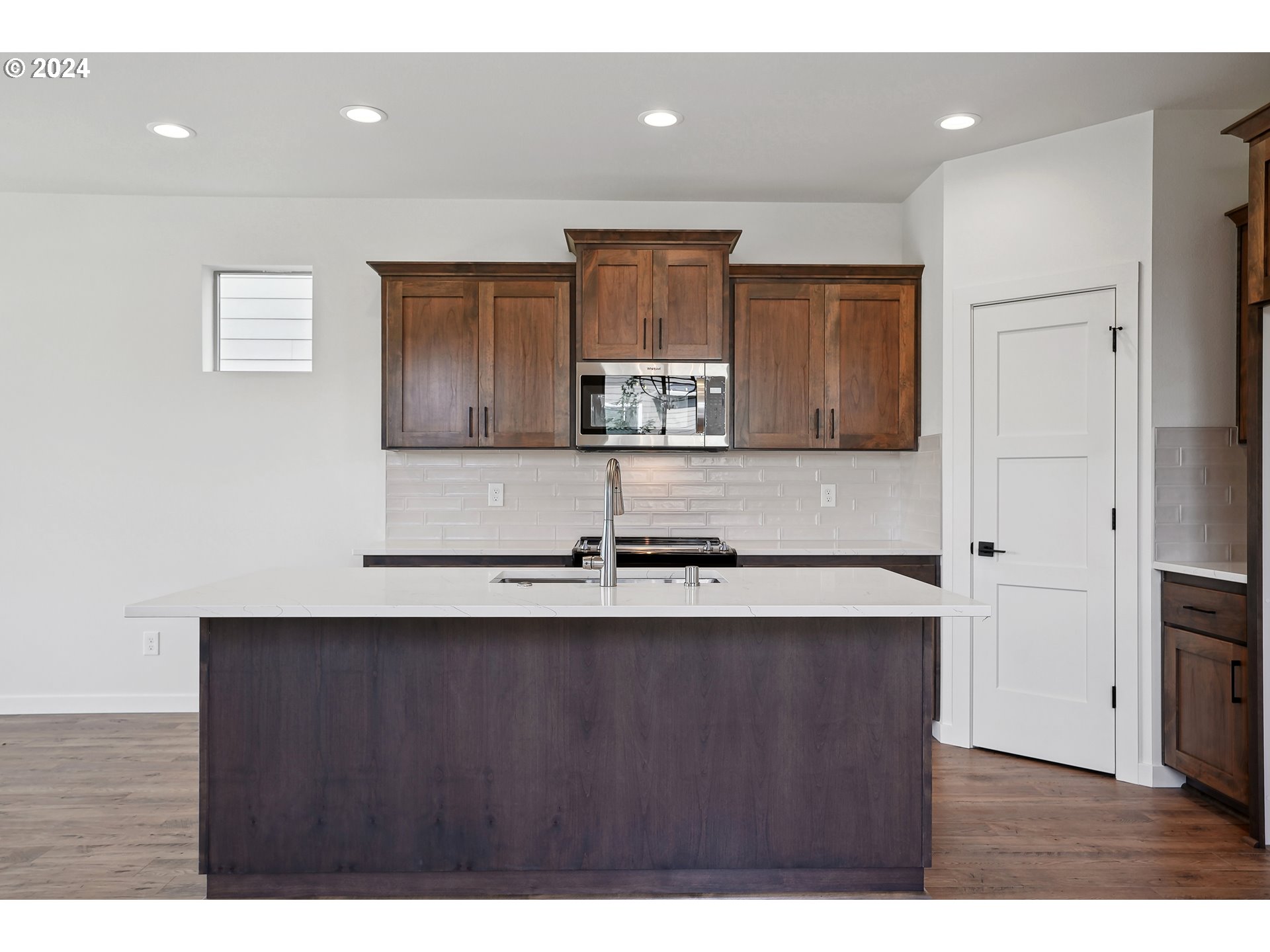 2541 South White Salmon Drive Ridgefield, WA 98642 - Photo 7 of 29 a kitchen with kitchen island granite countertop wooden cabinets and a sink