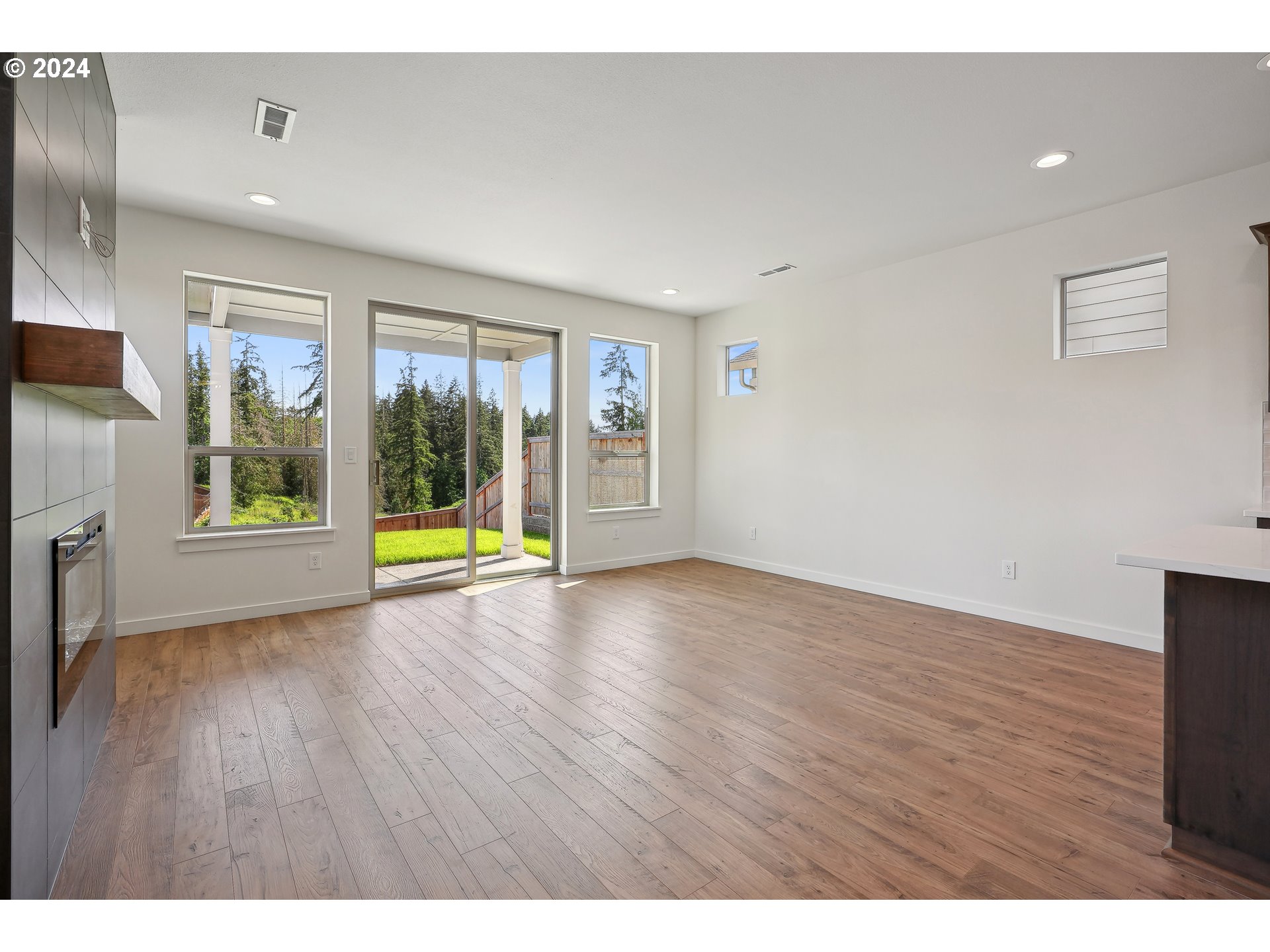2541 South White Salmon Drive Ridgefield, WA 98642 - Photo 10 of 29 a view of an empty room with a window and wooden floor