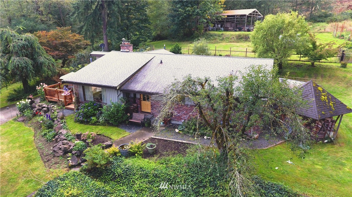20431 Welch Road Snohomish, WA 98296 - Photo 1 of 25 a view of a patio with table and chairs and potted plants