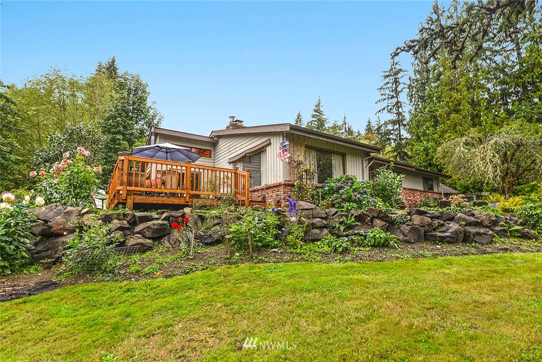 20431 Welch Road Snohomish, WA 98296 - Photo 2 of 25 a view of a house with a big yard and large trees