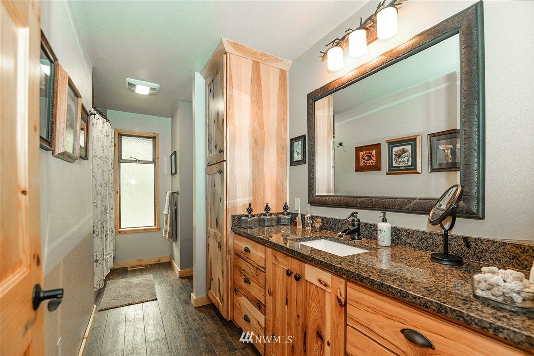 20431 Welch Road Snohomish, WA 98296 - Photo 14 of 25 a bathroom with a double vanity sink and a mirror