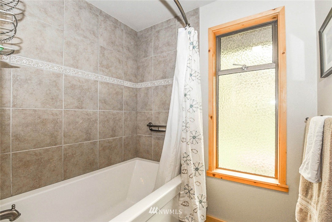 20431 Welch Road Snohomish, WA 98296 - Photo 15 of 25 a bathroom with a bathtub and shower