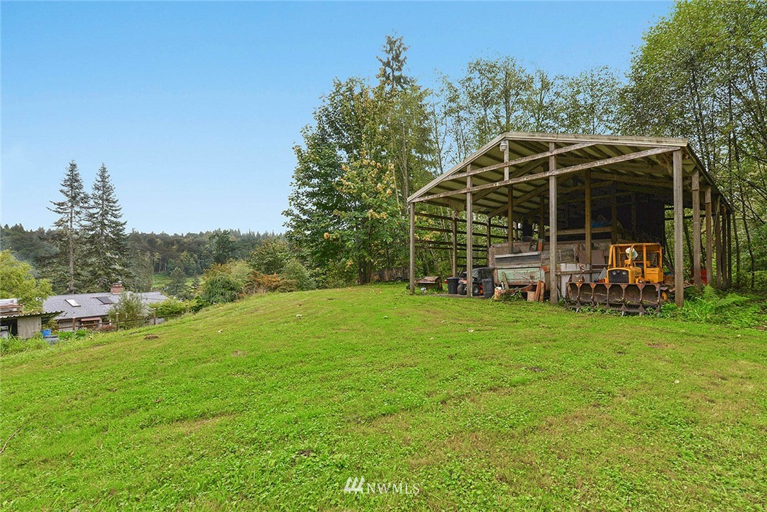20431 Welch Road Snohomish, WA 98296 - Photo 20 of 25 a view of a wooden deck with a big yard and potted plants and large trees