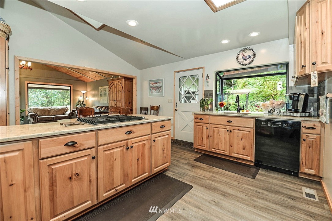 20431 Welch Road Snohomish, WA 98296 - Photo 7 of 25 a kitchen with stainless steel appliances a sink a stove and cabinets