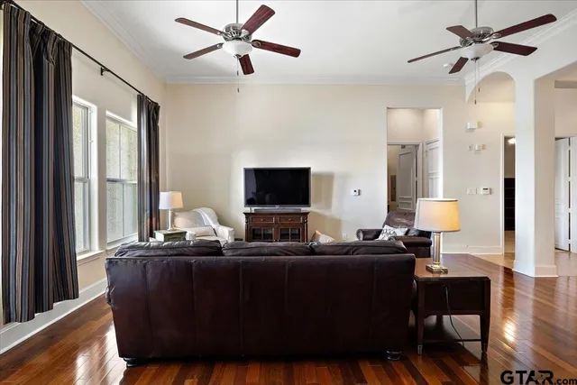 a bedroom with a bed lamp and a large window