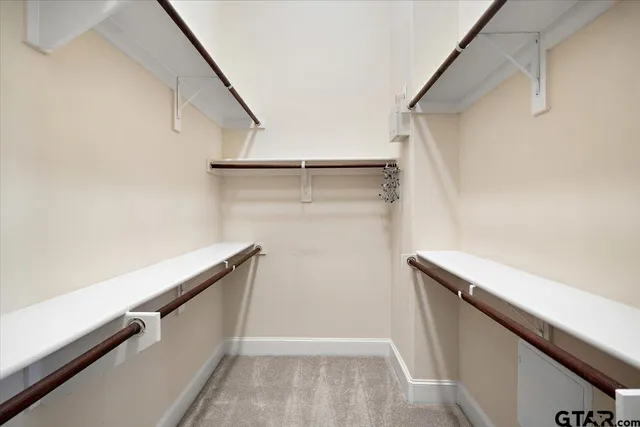 a white toilet sitting next to a white wall