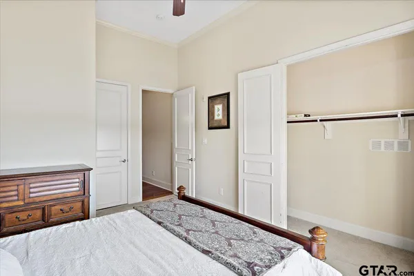 a bedroom with a bed and a dresser