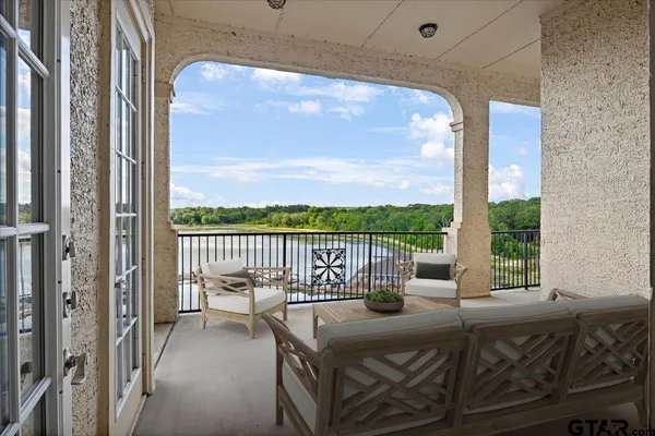 a view of a balcony with floor to ceiling window