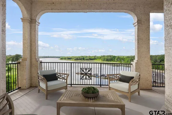 a balcony with furniture and a potted plant