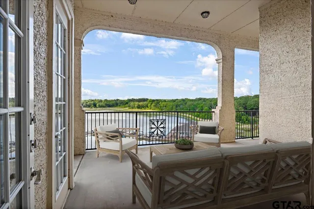 a balcony with furniture and a potted plant