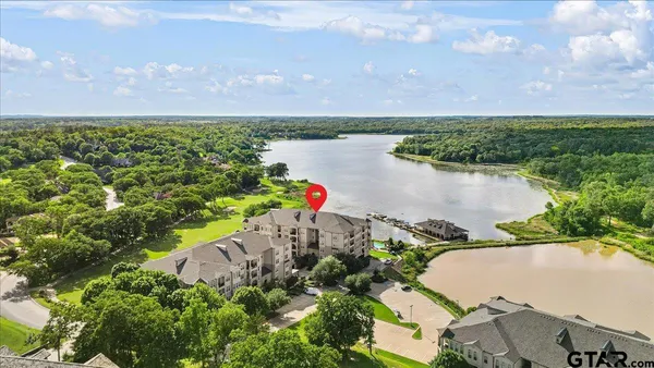 an aerial view of a house with a lake view