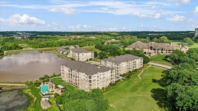 an aerial view of a house with a lake view