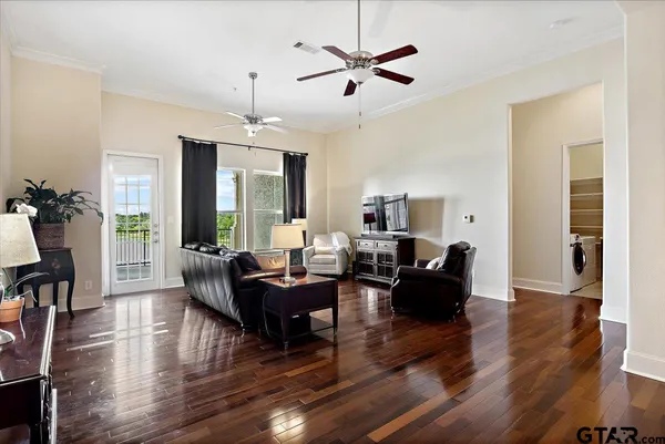 a living room with furniture or chandelier and a wooden floor