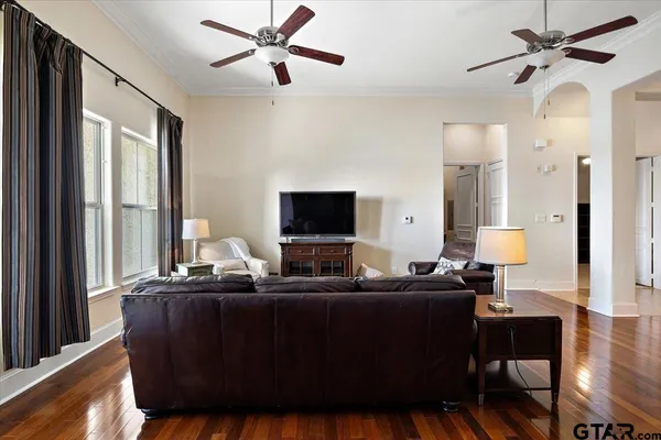 a living room with furniture wooden floor and a flat screen tv