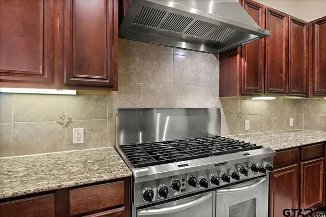a stove top oven sitting inside of a kitchen