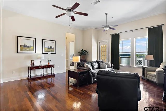 a living room with furniture or chandelier and a wooden floor
