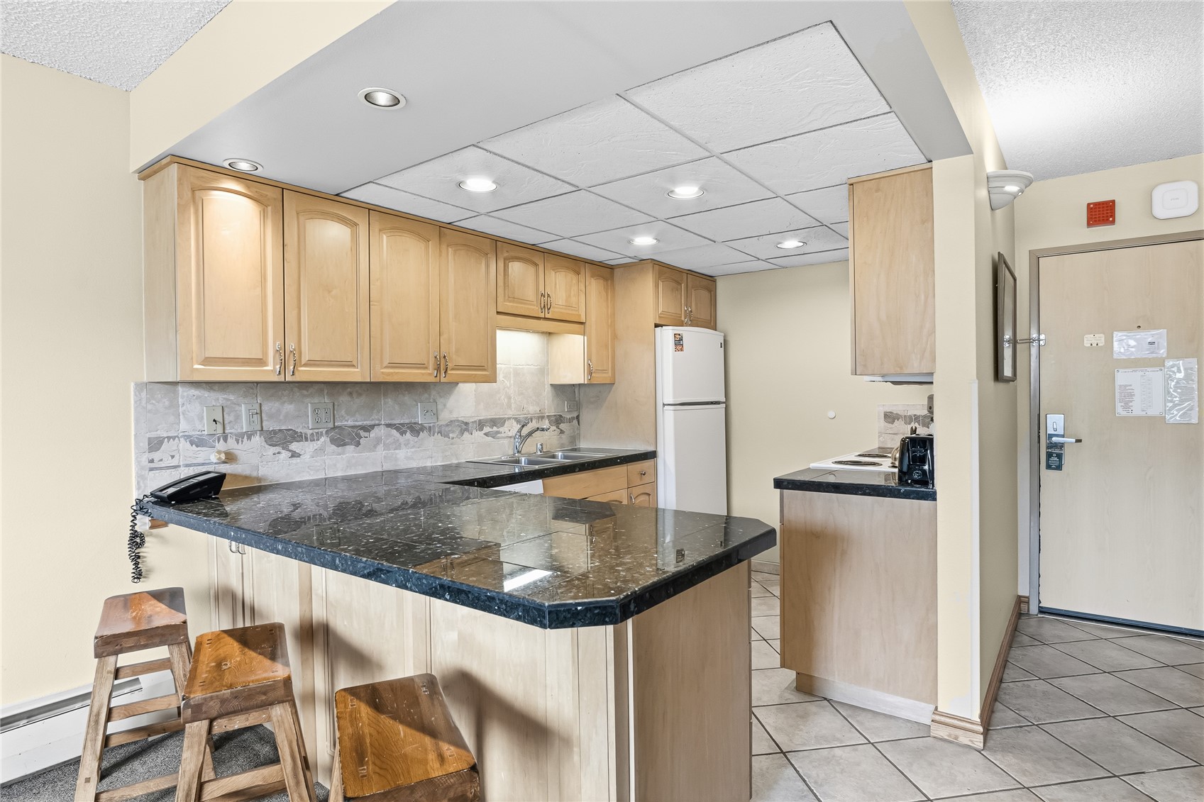 611 Village Road, Unit 24260 Breckenridge, CO 80424 - Photo 9 of 50 a kitchen with stainless steel appliances granite countertop a sink and a refrigerator