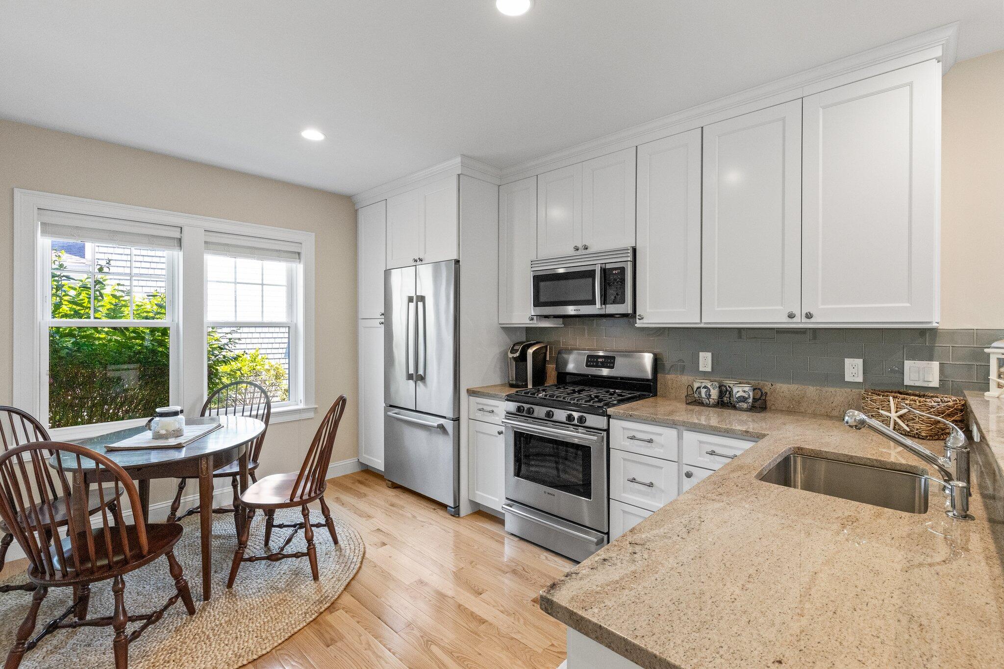 22 Saltwater Circle Mashpee, MA 02649 - Photo 14 of 53 a kitchen with stainless steel appliances granite countertop a stove a sink a microwave and a refrigerator