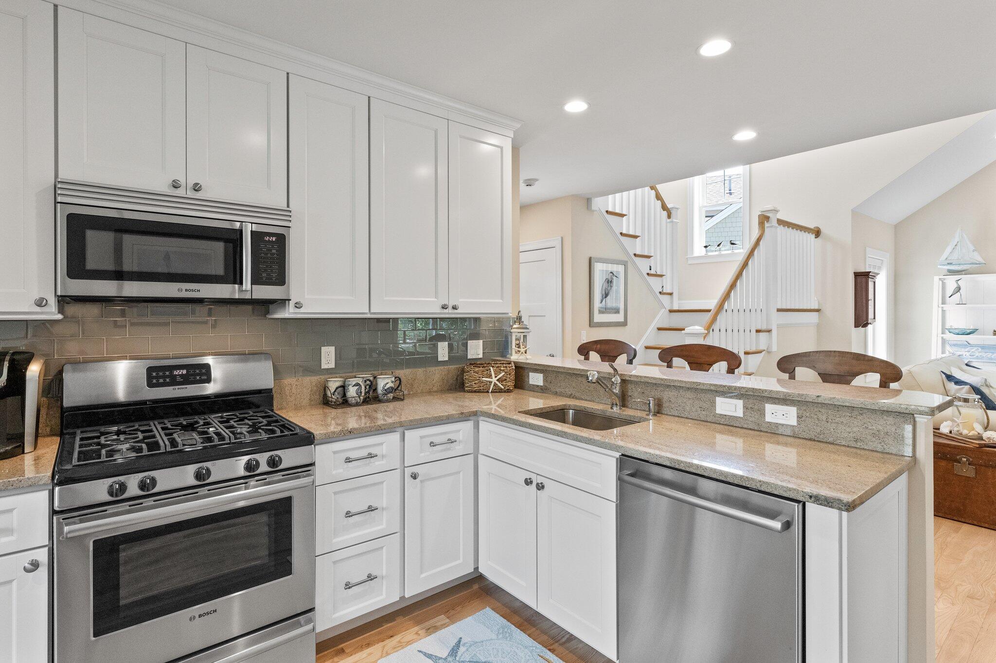 22 Saltwater Circle Mashpee, MA 02649 - Photo 15 of 53 a kitchen with appliances a sink and cabinets