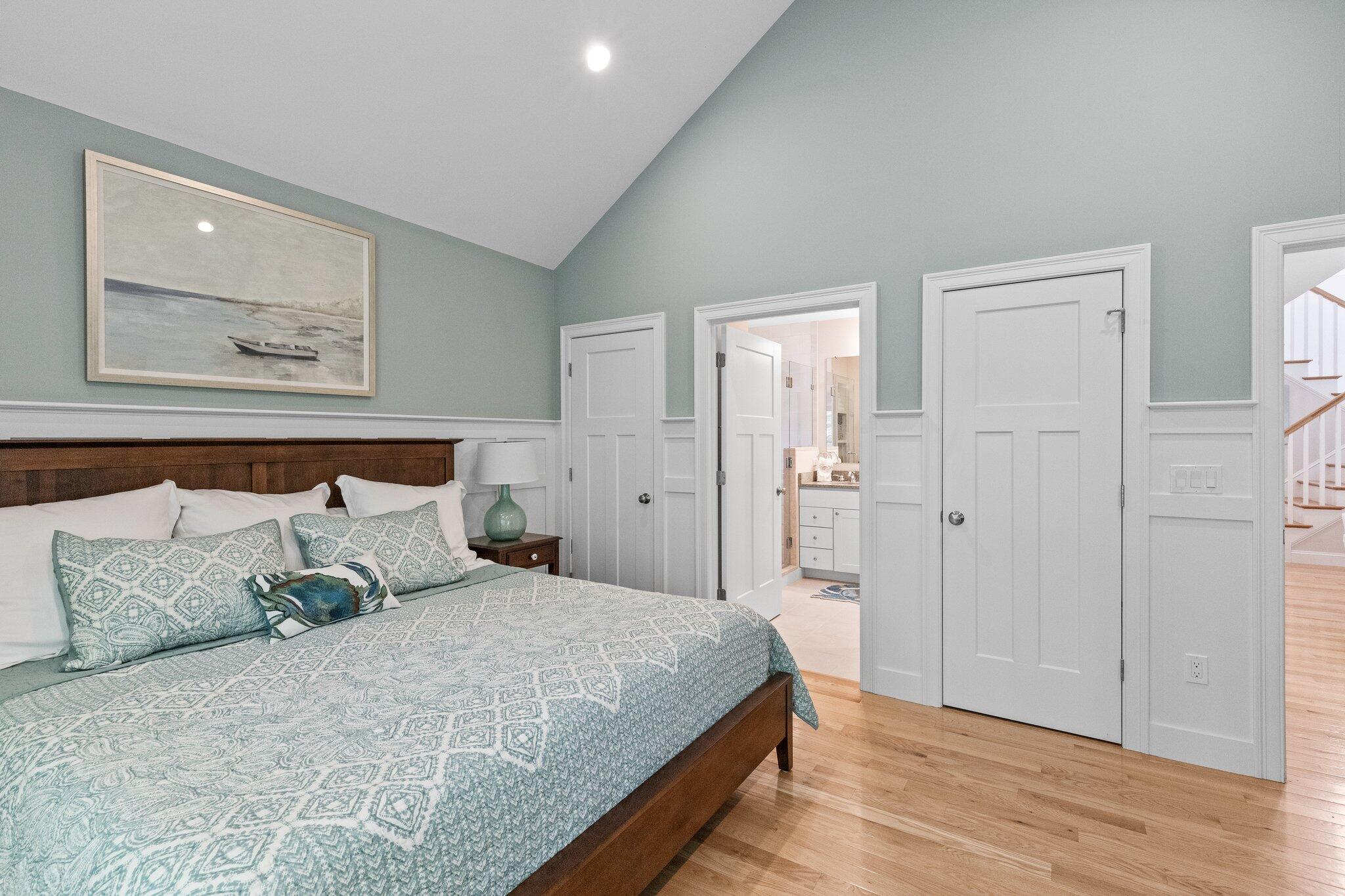 22 Saltwater Circle Mashpee, MA 02649 - Photo 19 of 53 a large bed in a white room with wooden floor