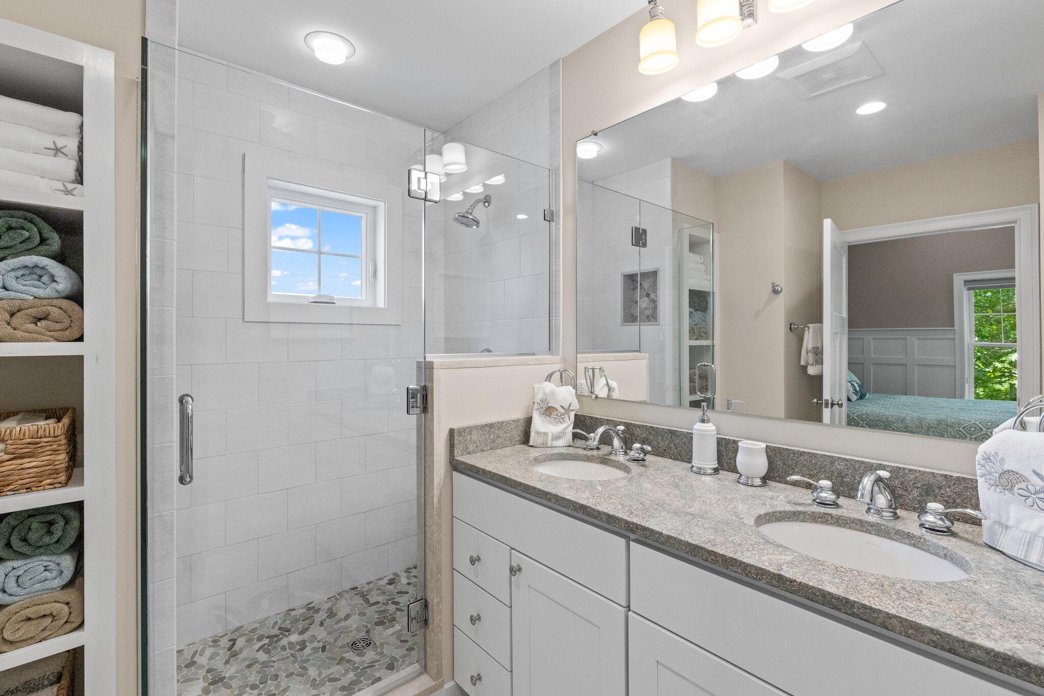 22 Saltwater Circle Mashpee, MA 02649 - Photo 21 of 53 a bathroom with a granite countertop double vanity sink a mirror and shower