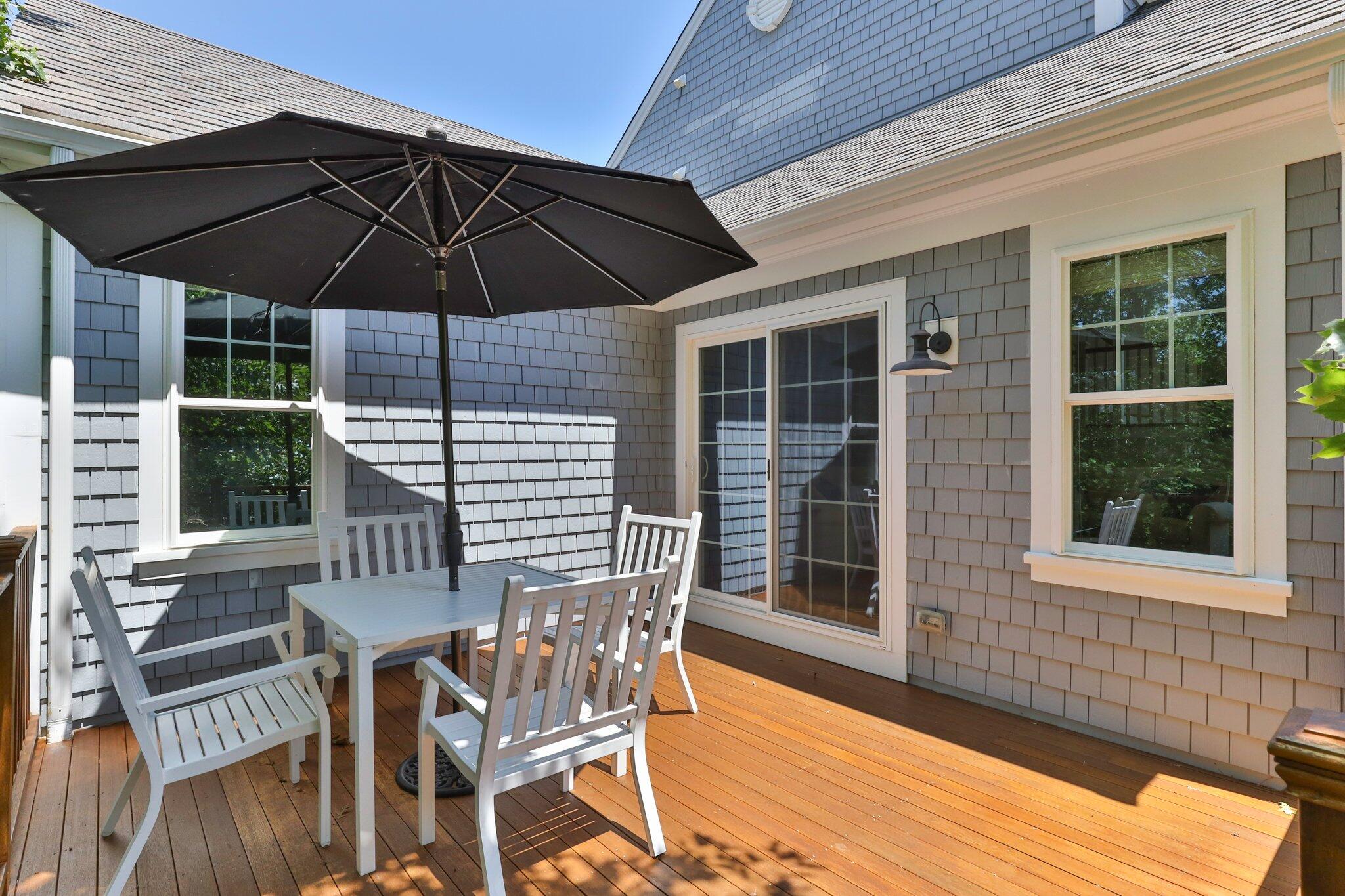 22 Saltwater Circle Mashpee, MA 02649 - Photo 36 of 53 a table and chairs in patio of the house