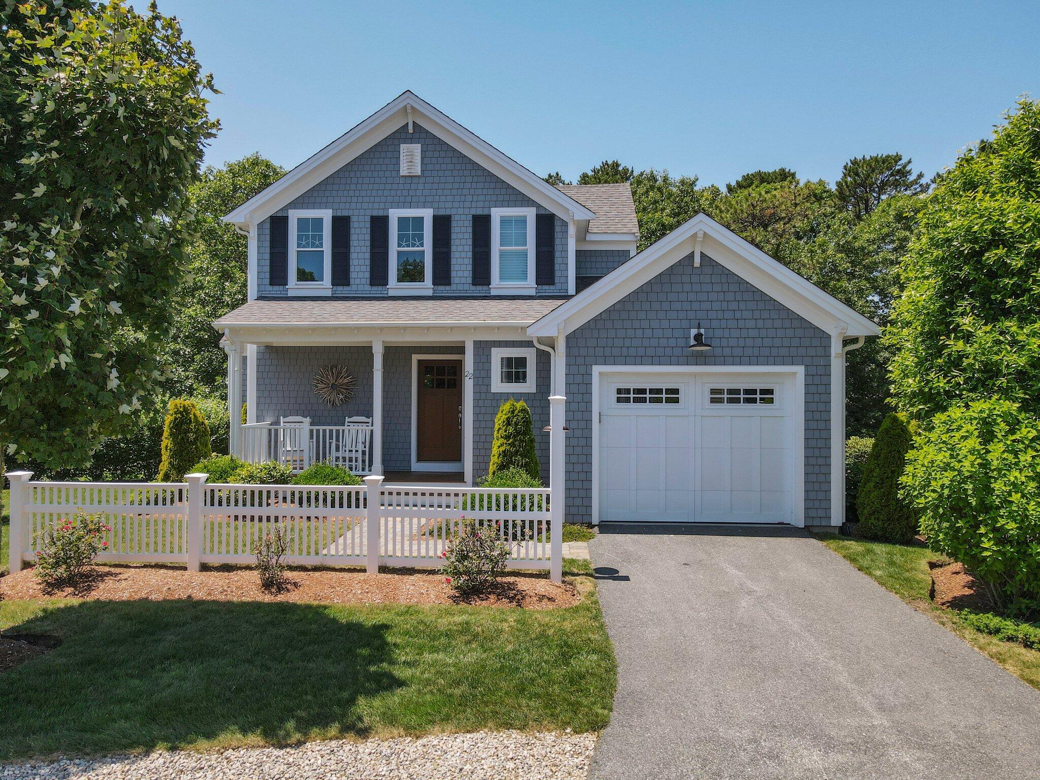 22 Saltwater Circle Mashpee, MA 02649 - Photo 38 of 53 a front view of a house with a yard and garage